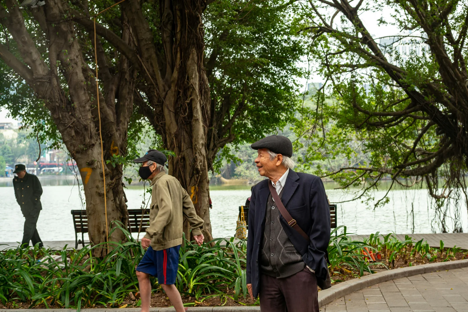 Older men standing by a park lake